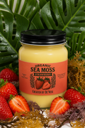 A jar of Organic Sea Moss Strawberry flaxseed butter, surrounded by fresh whole and sliced strawberries on a clean white background.